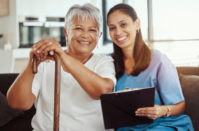 Caregiver and elderly smiling